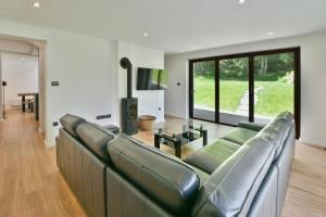 a living room with a couch and a table at Villa Belica in Bohinj
