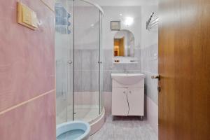 a bathroom with a shower and a toilet and a sink at Centralsquad in Mangalia +4 photos