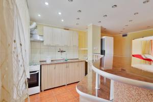 a kitchen with white cabinets and a counter top at Centralsquad in Mangalia