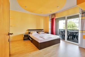 a bedroom with a bed and a dining room at Centralsquad in Mangalia