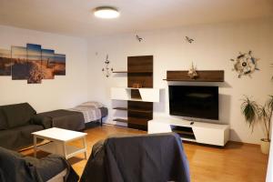 a living room with a flat screen tv and a couch at Paola Apartment in Pula