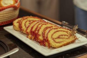 a piece of cake on a plate on a table at Pousada Lua Rosa in Piranhas