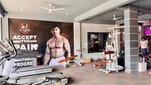a gym with a poster of a man on the wall at Hotel Gurukripa in Harsola +24 photos