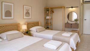 a bedroom with two beds and a mirror at Ciello Hotel Bodrum Adults Only 14 in Bodrum City +28 photos