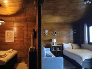 a bedroom with a bed and a couch in a room at Popa Cabana in Sibiu +37 photos