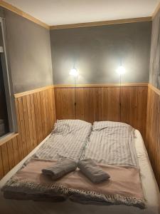 a bed in a room with two pillows on it at Vestra-Fíflholt cabin 3 in Hvolsvöllur