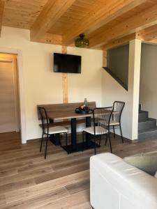 a dining room with a wooden table and chairs at Mirtillo in Tassullo