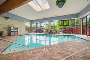 a large swimming pool in a building with windows at The Inn On The River in Pigeon Forge