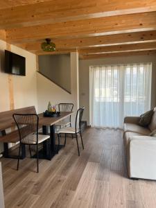 a living room with a table and chairs and a couch at Mirtillo in Tassullo