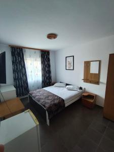 a bedroom with a bed and a tv in it at vila CALIL in Eforie Nord