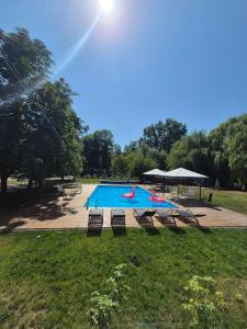 a large swimming pool with a group of chairs around it at Sunpark in Vadul lui Vodă +12 photos