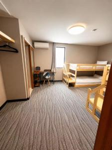 a room with two bunk beds and a desk at White Chalet Niseko in Niseko