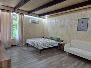 a bedroom with a bed and a couch at Sunpark in Vadul lui Vodă