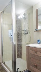 a bathroom with a shower with a glass door at Le gîte du comte 2/3 personnes in Saint-Germain-de-Calberte +12 photos