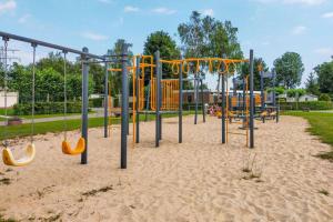 a playground in a park with playground equipment at Steam & Dream - Hottub & Sauna Retreat - Free WiFi - Full Privacy - Luxury Experience in Heinkensand
