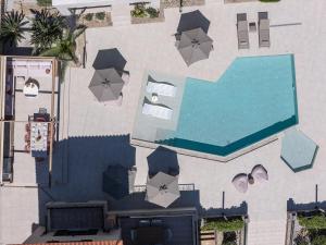 an overhead view of a pool with umbrellas and a swimming pool at Argyro Villa in Bali