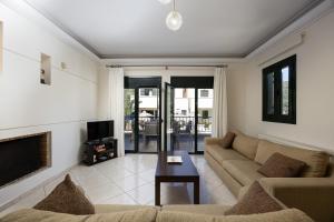 a living room with a couch and a fireplace at Argyro Villa in Bali