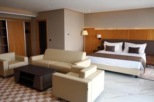 a hotel room with a bed and a couch at Hotel Deauville El jadida in El Jadida +81 photos