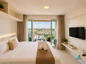 a hotel room with a large bed and a large window at Fortaleza Sul by Holiday Stays in Fortaleza