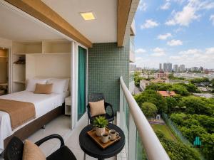 a bedroom with a bed and a balcony with a view at Fortaleza Sul by Holiday Stays in Fortaleza