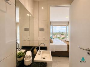 a bathroom with a sink and a bed with a window at Fortaleza Sul by Holiday Stays in Fortaleza +22 photos
