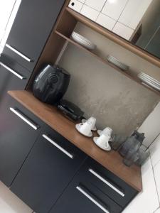 a kitchen counter with a camera and controllers on it at Refúgio Charmoso 1 in Volta Redonda