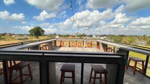 a view from the top of a balcony with stools at Joni Ubud Hostel in Ubud
