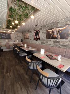 a restaurant with tables and chairs and a bull head on the wall at Hotel Am Hopfenmarkt in Rostock +21 photos