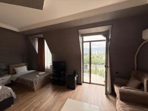 a hotel room with a bed and a sliding glass door at Hotel RichI G A in Tbilisi City +42 photos
