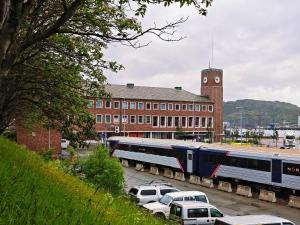 a train parked in a parking lot in front of a building at Bodo Motel Norway in Bodø