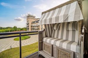 a balcony with awning and a view of a building at Francis Drake Suite - 5-Sterne Wellnessurlaub mit Ostseeblick in Wustrow