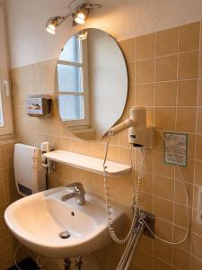 a bathroom with a sink and a mirror at MiTi Sleep and Go in Bernkastel-Kues
