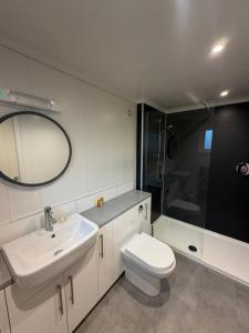 a bathroom with a sink and a toilet and a shower at Inverbeg Holiday Park in Luss +55 photos
