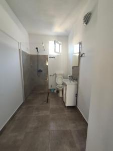 a small bathroom with a toilet and a sink at vila CALIL in Eforie Nord +21 photos