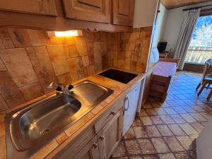 a kitchen with a sink and a counter at Studio Ban rouge, Chez Francine in Notre-Dame-de-Bellecombe
