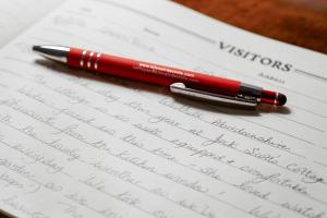 a red pen sitting on top of a notebook at Jock Scott Cottage in Dunkeld +16 photos