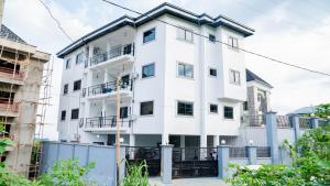 a white building with a black roof at Moonlight heaven suites in Limbe
