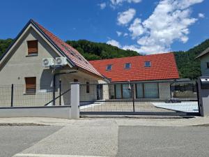 a building with a fence in front of it at Apartment house Petra in Cerklje na Gorenjskem