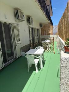 a patio with a table and chairs on a building at Sole & Mare Rooms Briatico in Briatico