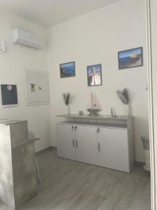 a kitchen with a sink and a counter at Sole & Mare Rooms Briatico in Briatico