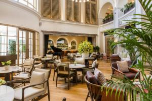 a restaurant with tables and chairs and plants at DLF Club 4 in Gurgaon