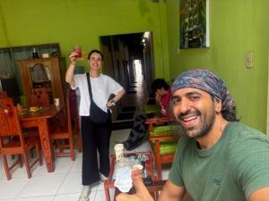 a woman standing in a room with a man at Amazon City House Iquitos in Iquitos +7 photos