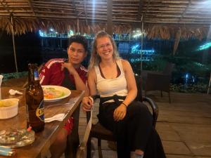 a man and a woman sitting at a table with a plate of food at Amazon City House Iquitos in Iquitos