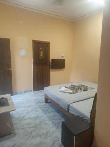 a bedroom with a bed in a room at Theglassystay in Raipur
