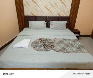 a bed with two pillows on top of it at Theglassystay in Raipur