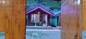 a view of a house through a door at Mahi camping in Jagatsukh
