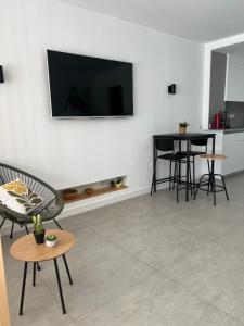 a living room with a flat screen tv on a wall at Apartaestudio Playa Paraíso in Aguadulce