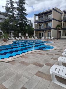 a swimming pool in front of a building at Sol e Mar in Sunny Beach