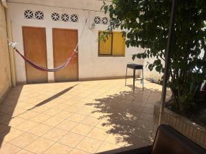 a house with a hammock on the side of it at Amazon City House Iquitos in Iquitos
