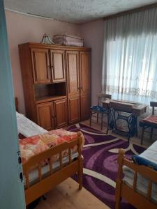 a bedroom with two beds and a desk and a table at Do Vuceljica in Andrijevica
